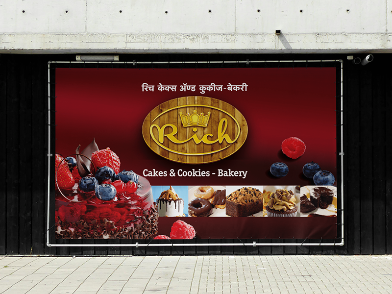 Bakery storefront billboard featuring cakes, cookies, berries, and premium dessert branding